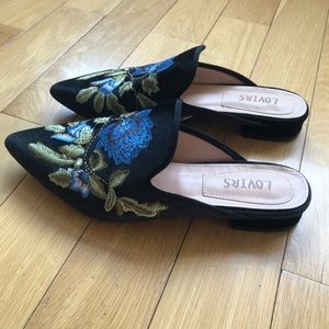 Lovirs embroidered black mules.